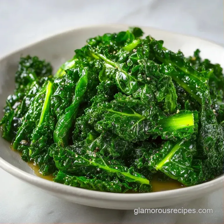 Artfully plated dark leafy greens topped with creamy cheese curls and toasted pine nuts on a clean white ceramic plate.